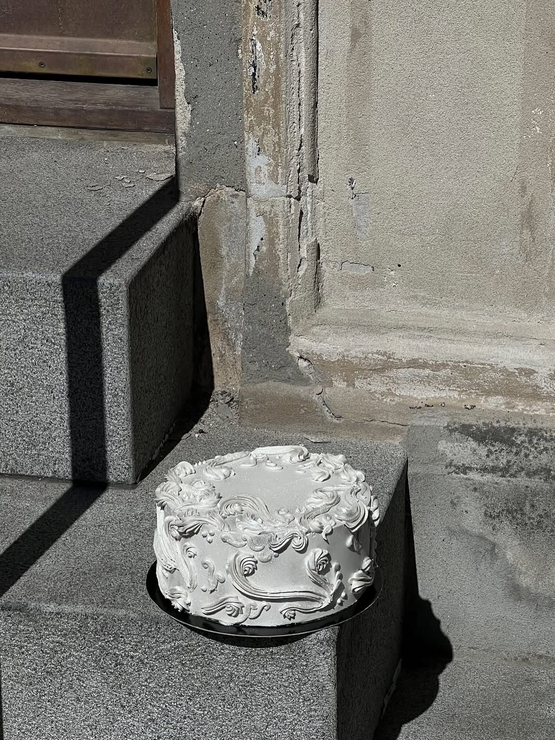 Silver baroque cake on weathered stone steps